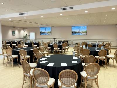Salle Paris dressée en tables rondes nappées de noir